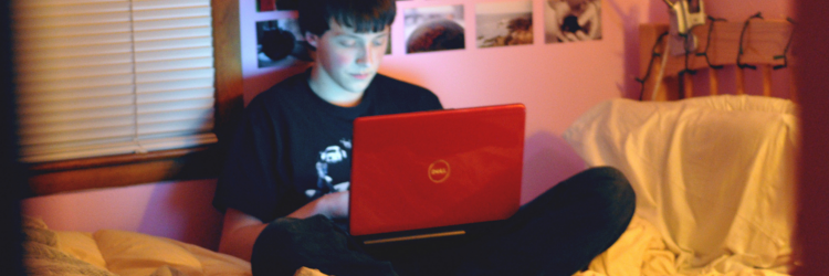 teen boy using laptop